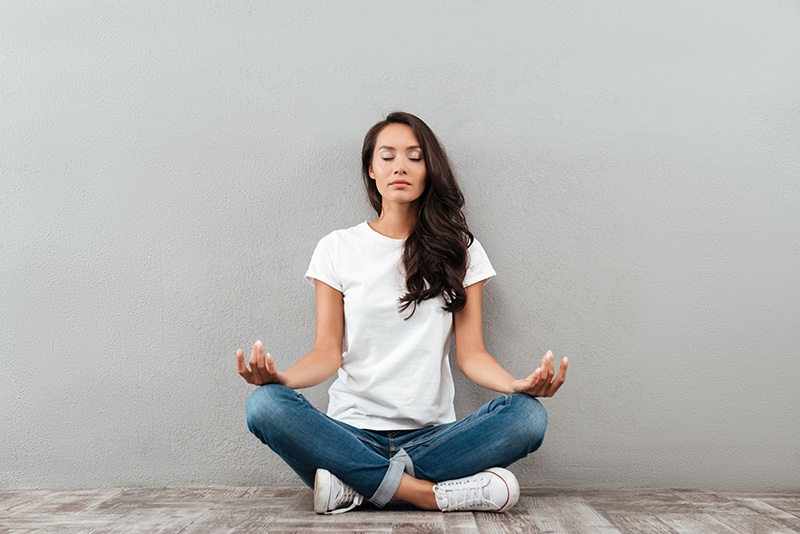 A woman practices meditation, one of the best relapse prevention techniques.