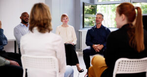 People participate in therapy for a dual diagnosis IOP.