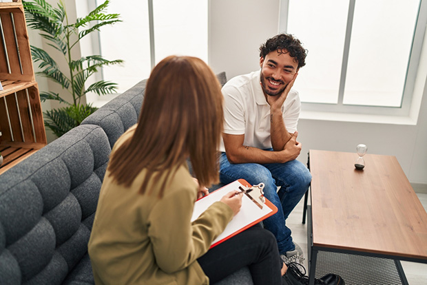 A man participates in therapy for addiction and trauma recovery.