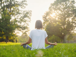 A woman practices meditation, one of the coping skills for relapse prevention.